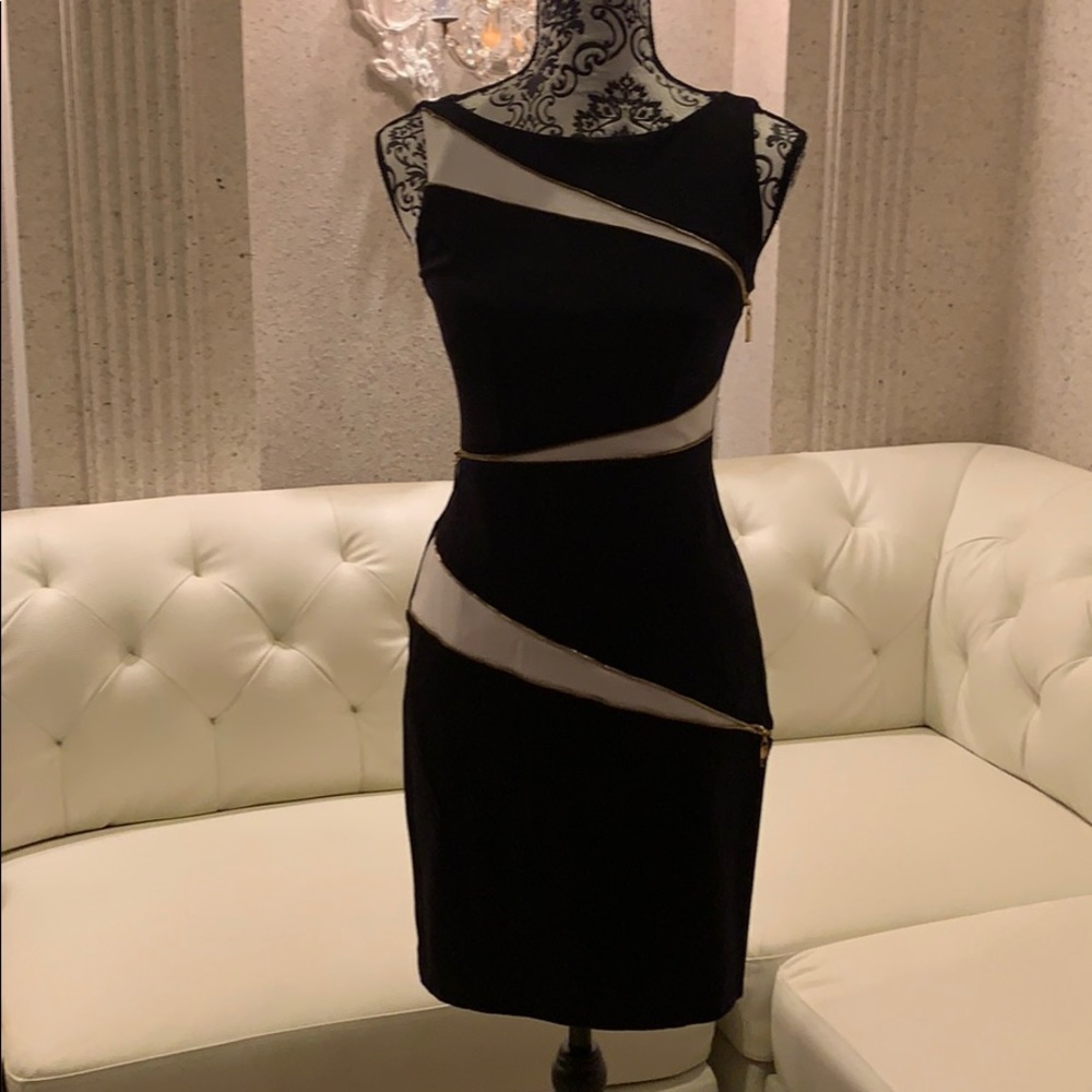Cache dress with gold zipper details.